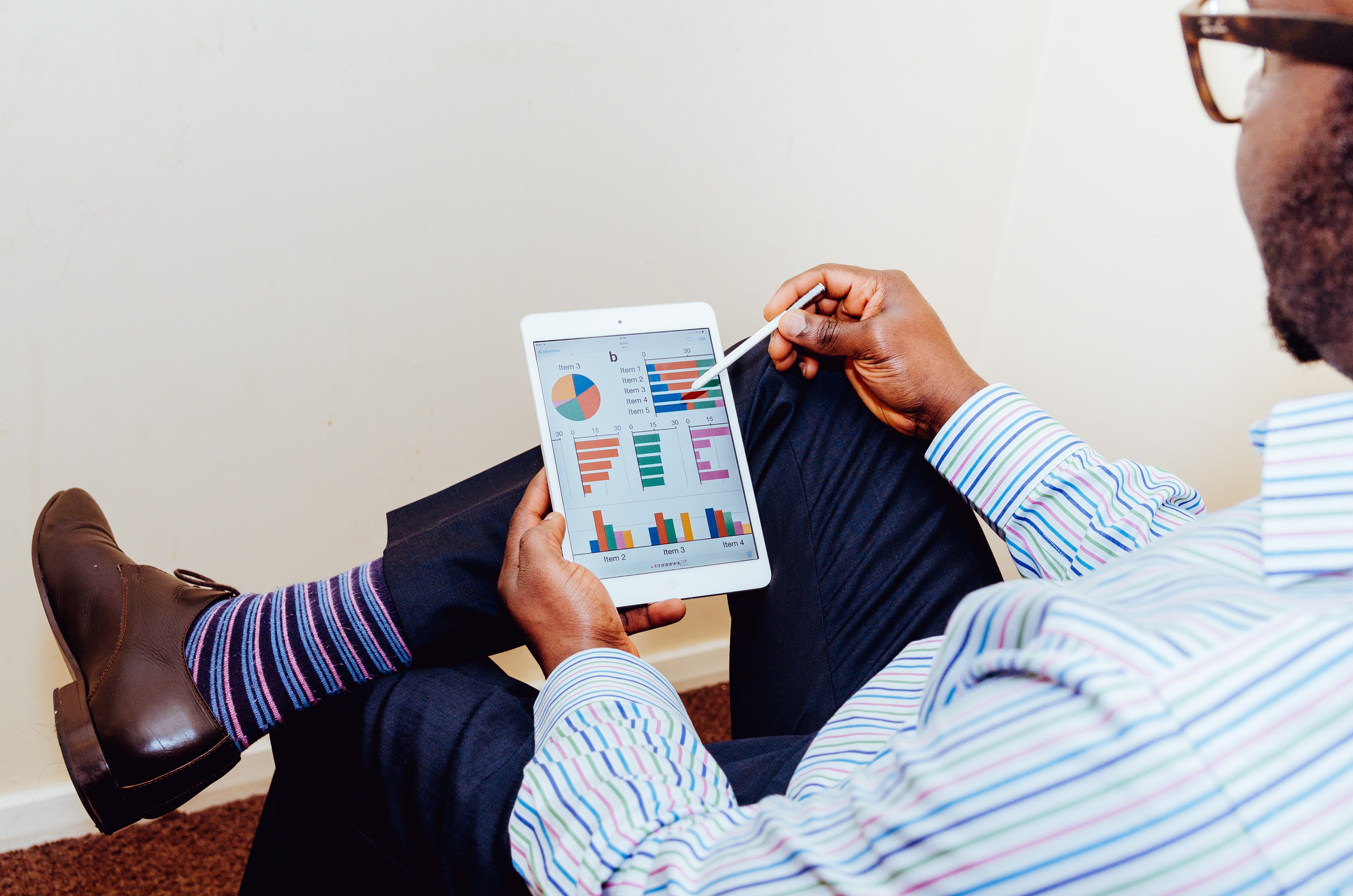 photo of man interacting with his tablet