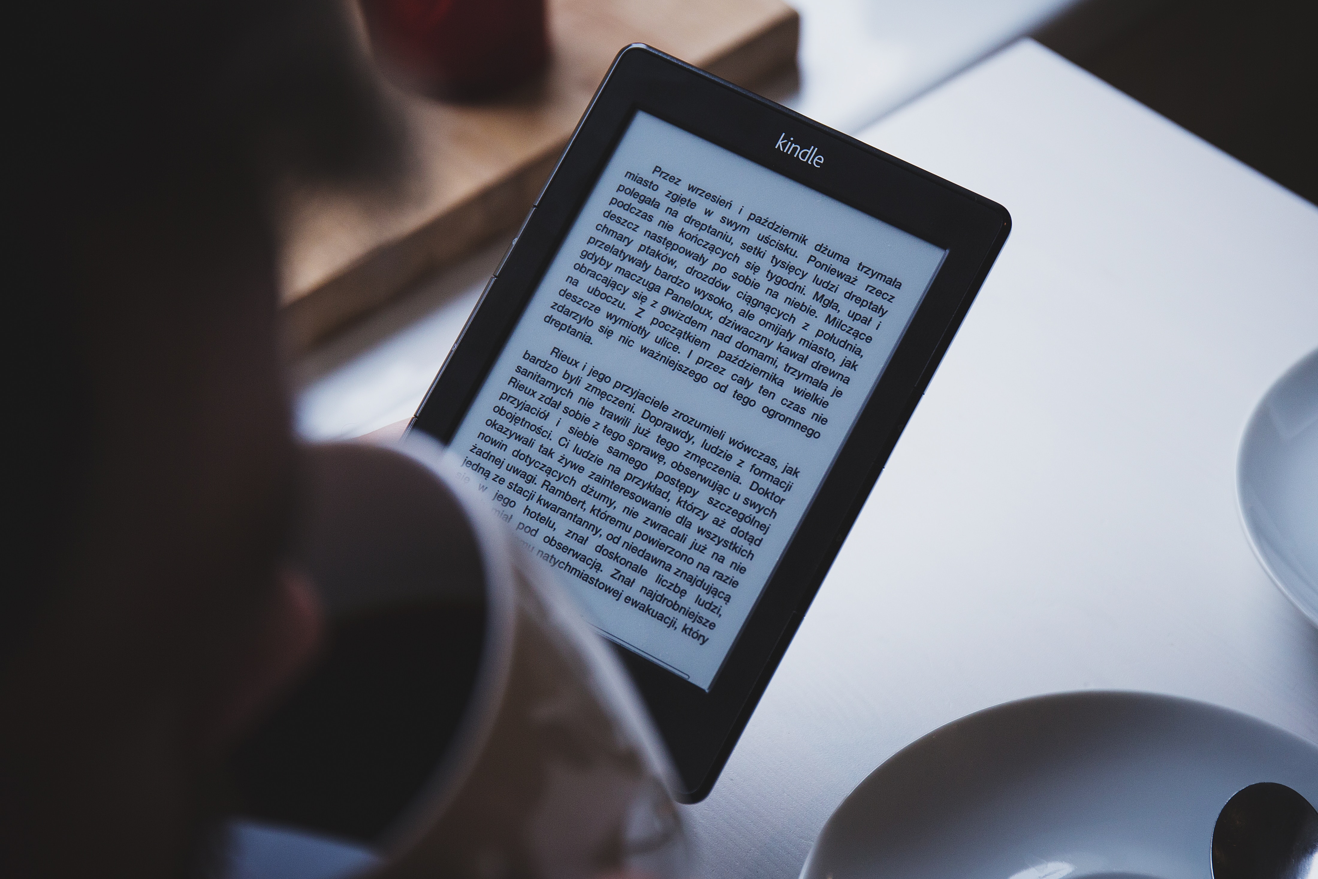 photo of woman reading a tablet
